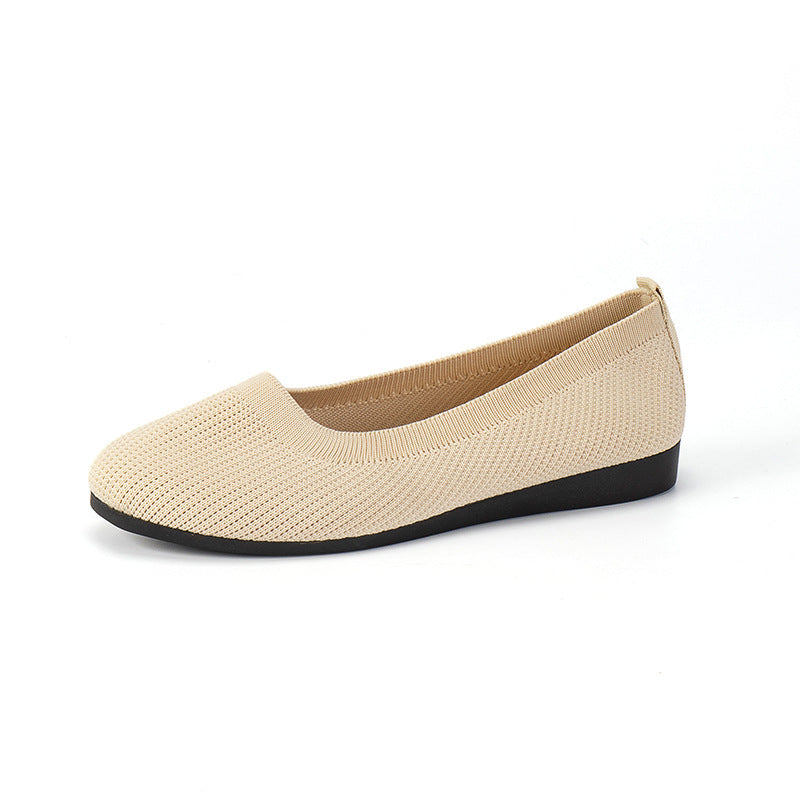 Women's creamy white slip-on knit mesh flat shoes with round toe and rubber sole, side view